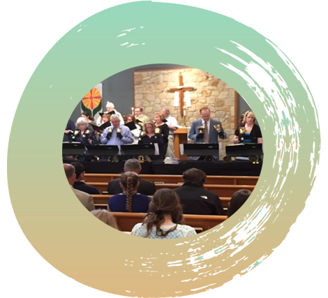 Bell choir performing in the front of the church